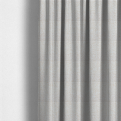 The fabric used to create these made-to-measure curtains is a light beige upholstery fabric with a fine, textured weave.