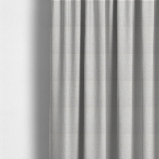 The fabric used to create these made-to-measure curtains is a light beige upholstery fabric with a fine, textured weave.