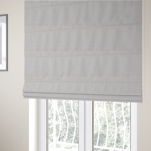 The fabric used to create these Roman blinds is a light beige upholstery fabric with a fine, textured weave.