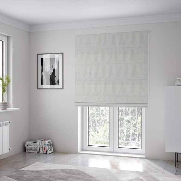 The fabric used to create these Roman blinds is a light beige upholstery fabric with a fine, textured weave.