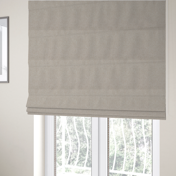 The fabric used to create these Roman blinds is a light beige and tan upholstery fabric with a fine, multi-tonal textured weave.