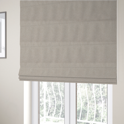The fabric used to create these Roman blinds is a light beige and tan upholstery fabric with a fine, multi-tonal textured weave.