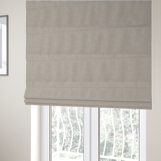 The fabric used to create these Roman blinds is a light beige and tan upholstery fabric with a fine, multi-tonal textured weave.