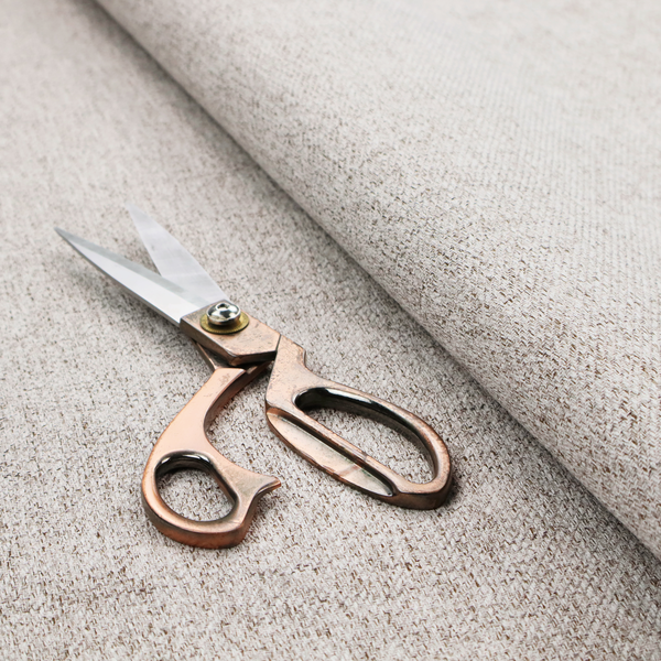A taupe and grey upholstery fabric with a dense, multi-tonal textured weave.