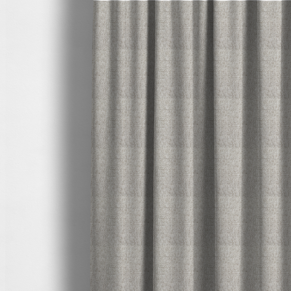 The fabric used to create these made-to-measure curtains is a taupe and grey upholstery fabric with a dense, multi-tonal textured weave.