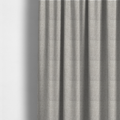 The fabric used to create these made-to-measure curtains is a taupe and grey upholstery fabric with a dense, multi-tonal textured weave.