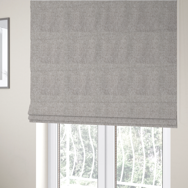 The fabric used to create these Roman blinds is a taupe and grey upholstery fabric with a dense, multi-tonal textured weave.