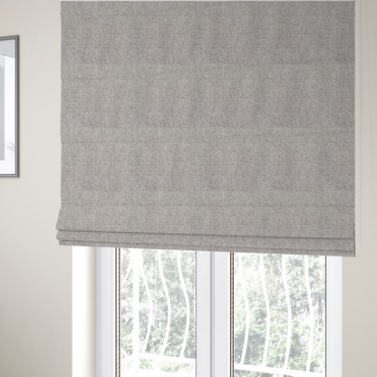 The fabric used to create these Roman blinds is a taupe and grey upholstery fabric with a dense, multi-tonal textured weave.