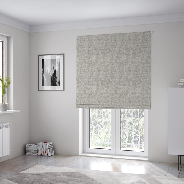 The fabric used to create these Roman blinds is a taupe and grey upholstery fabric with a dense, multi-tonal textured weave.