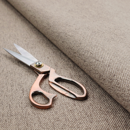 A warm grey and brown upholstery fabric with a dense, diagonal textured weave.