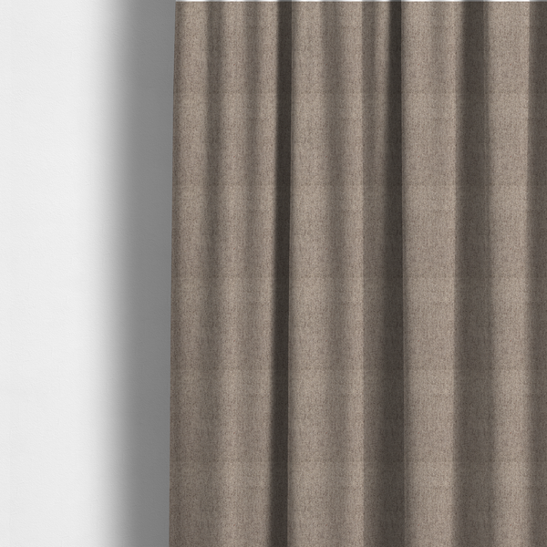 The fabric used to create these made-to-measure curtains is a warm grey and brown upholstery fabric with a dense, diagonal textured weave.