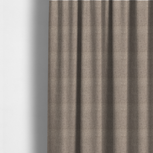 The fabric used to create these made-to-measure curtains is a warm grey and brown upholstery fabric with a dense, diagonal textured weave.