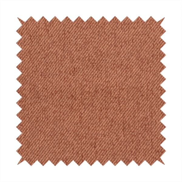 A rust-orange upholstery fabric with a dense, diagonal textured weave.