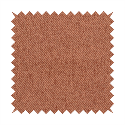 A rust-orange upholstery fabric with a dense, diagonal textured weave.