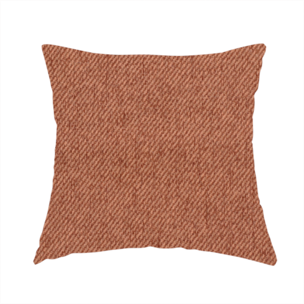 The fabric used to create this handmade cushion is a rust-orange upholstery fabric with a dense, diagonal textured weave.