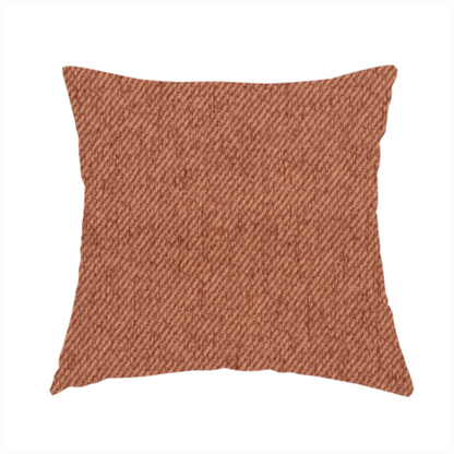 The fabric used to create this handmade cushion is a rust-orange upholstery fabric with a dense, diagonal textured weave.