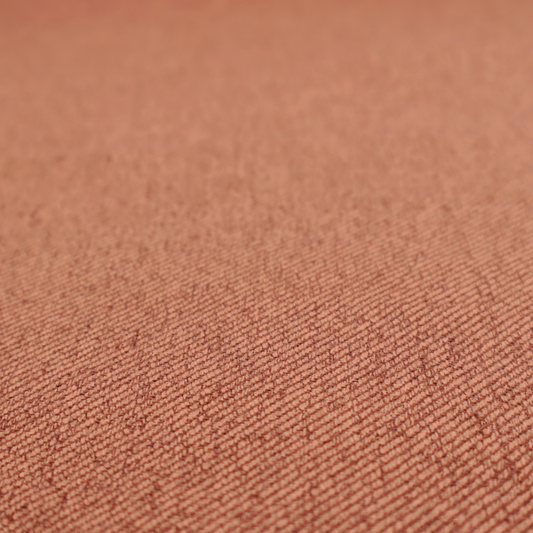 A rust-orange upholstery fabric with a dense, diagonal textured weave.