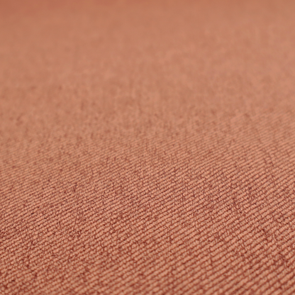 A rust-orange upholstery fabric with a dense, diagonal textured weave.