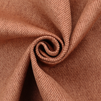 A rust-orange upholstery fabric with a dense, diagonal textured weave.