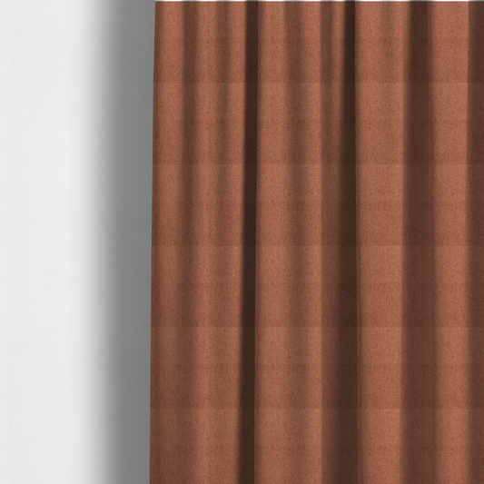 The fabric used to create these made-to-measure curtains is a rust-orange upholstery fabric with a dense, diagonal textured weave.