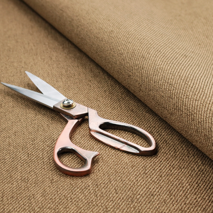 A golden-brown upholstery fabric with a dense, diagonal textured weave.