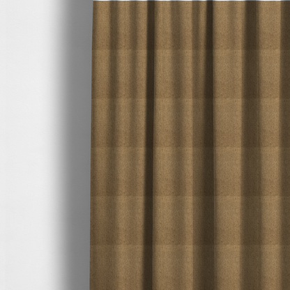 The fabric used to create these made-to-measure curtains is a golden-brown upholstery fabric with a dense, diagonal textured weave.