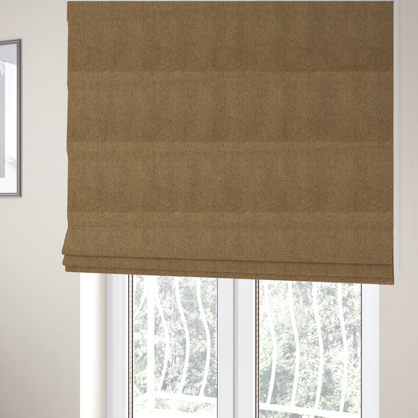 The fabric used to create these Roman blinds is a golden-brown upholstery fabric with a dense, diagonal textured weave.