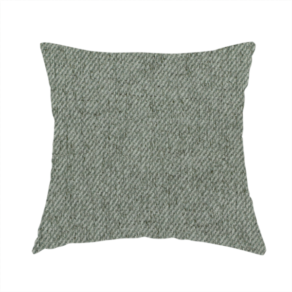 The fabric used to create this handmade cushion is a sage green upholstery fabric with a dense, diagonal textured weave.