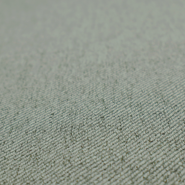 A sage green upholstery fabric with a dense, diagonal textured weave.