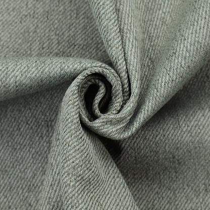 A sage green upholstery fabric with a dense, diagonal textured weave.