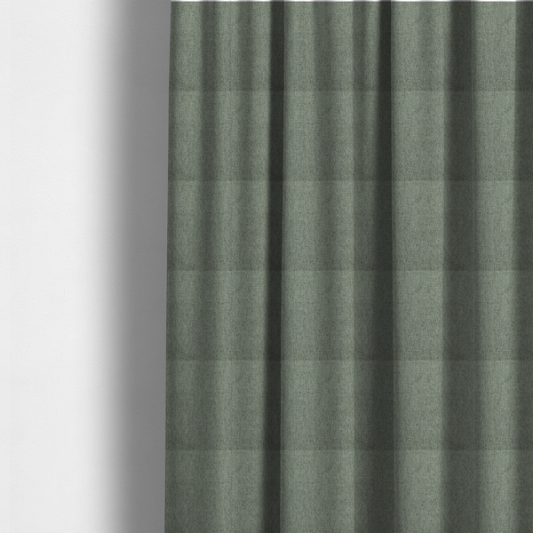 The fabric used to create these made-to-measure curtains is a sage green upholstery fabric with a dense, diagonal textured weave.
