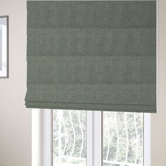 The fabric used to create these Roman blinds is a sage green upholstery fabric with a dense, diagonal textured weave.