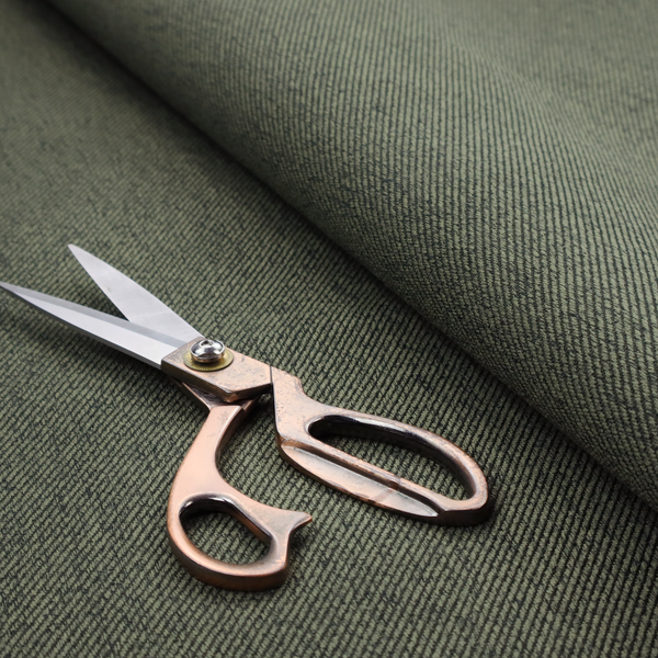 A dark forest green upholstery fabric with a dense, diagonal textured weave.
