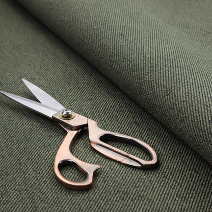 A dark forest green upholstery fabric with a dense, diagonal textured weave.