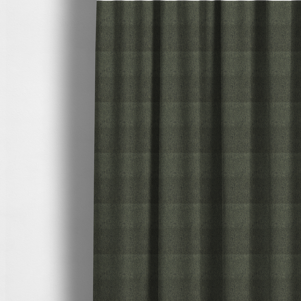 The fabric used to create these made-to-measure curtains is a dark forest green upholstery fabric with a dense, diagonal textured weave.