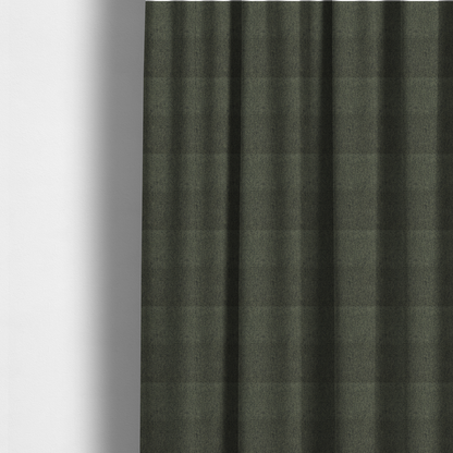 The fabric used to create these made-to-measure curtains is a dark forest green upholstery fabric with a dense, diagonal textured weave.
