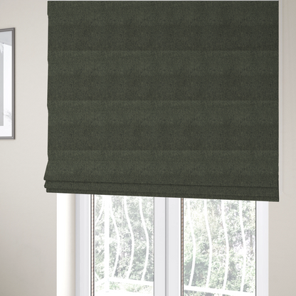 The fabric used to create these Roman blinds is a dark forest green upholstery fabric with a dense, diagonal textured weave.