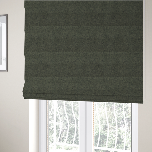 The fabric used to create these Roman blinds is a dark forest green upholstery fabric with a dense, diagonal textured weave.