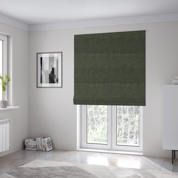 The fabric used to create these Roman blinds is a dark forest green upholstery fabric with a dense, diagonal textured weave.