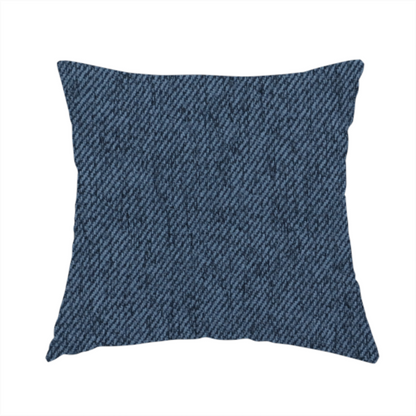 The fabric used to create this handmade cushion is a navy blue upholstery fabric with a dense, diagonal textured weave.