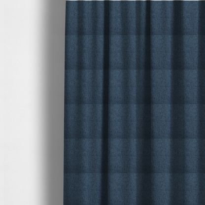 The fabric used to create these made-to-measure curtains is a navy blue upholstery fabric with a dense, diagonal textured weave.
