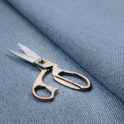 A mid-blue upholstery fabric with a dense, diagonal textured weave.