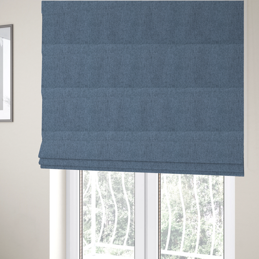 The fabric used to create these Roman blinds is a mid-blue upholstery fabric with a dense, diagonal textured weave.