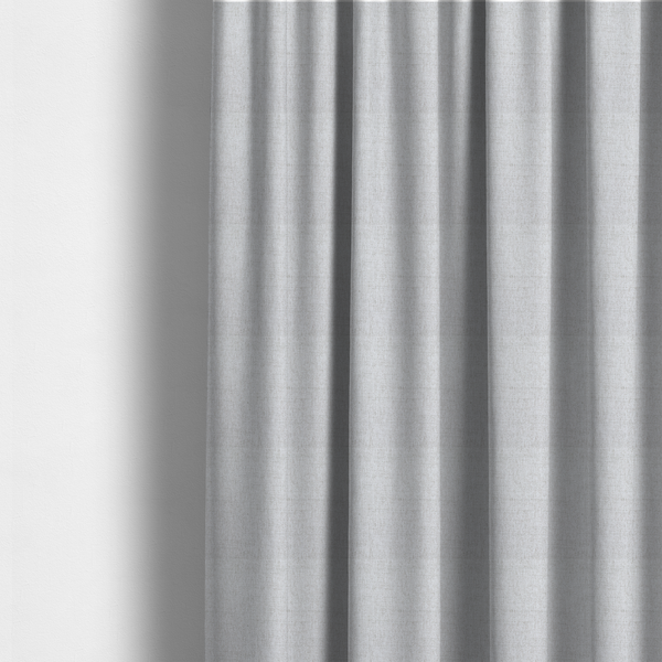 The fabric used to create these made-to-measure curtains is a light grey upholstery fabric with a fine, dense textured weave.