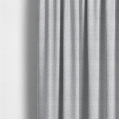 The fabric used to create these made-to-measure curtains is a light grey upholstery fabric with a fine, dense textured weave.