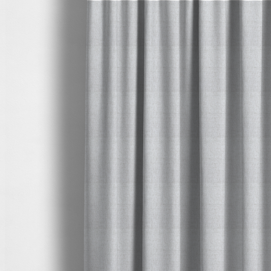 The fabric used to create these made-to-measure curtains is a light grey upholstery fabric with a fine, dense textured weave.