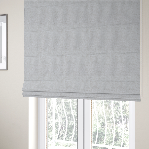 The fabric used to create these Roman blinds is a light grey upholstery fabric with a fine, dense textured weave.