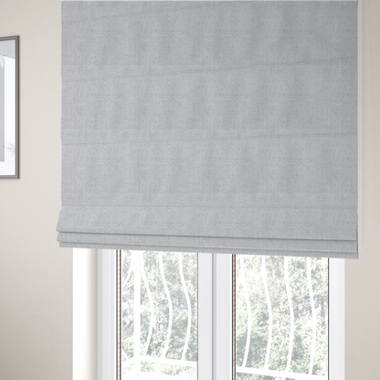 The fabric used to create these Roman blinds is a light grey upholstery fabric with a fine, dense textured weave.