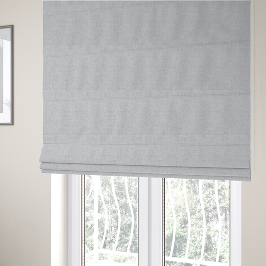 The fabric used to create these Roman blinds is a light grey upholstery fabric with a fine, dense textured weave.