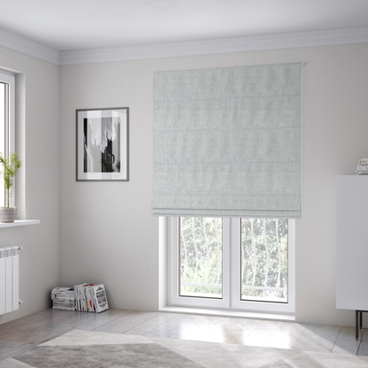 The fabric used to create these Roman blinds is a light grey upholstery fabric with a fine, dense textured weave.